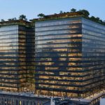 Aerial view of S&P Global's new headquarters in Manhattan, displaying the building's double-skin façade, green roof, and cutting-edge sustainable architectural elements.