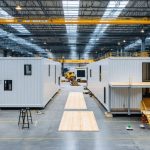 A split image contrasting modular home units being assembled in a factory on one side, and the vibrant assembly of prefabricated components on-site on the other, representing the differences between modular and prefab construction methods.