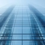 Conceptual illustration of a modern skyscraper showcasing smart glass technology, with windows shifting from clear to tinted states, highlighting energy efficiency and advanced architectural integration.